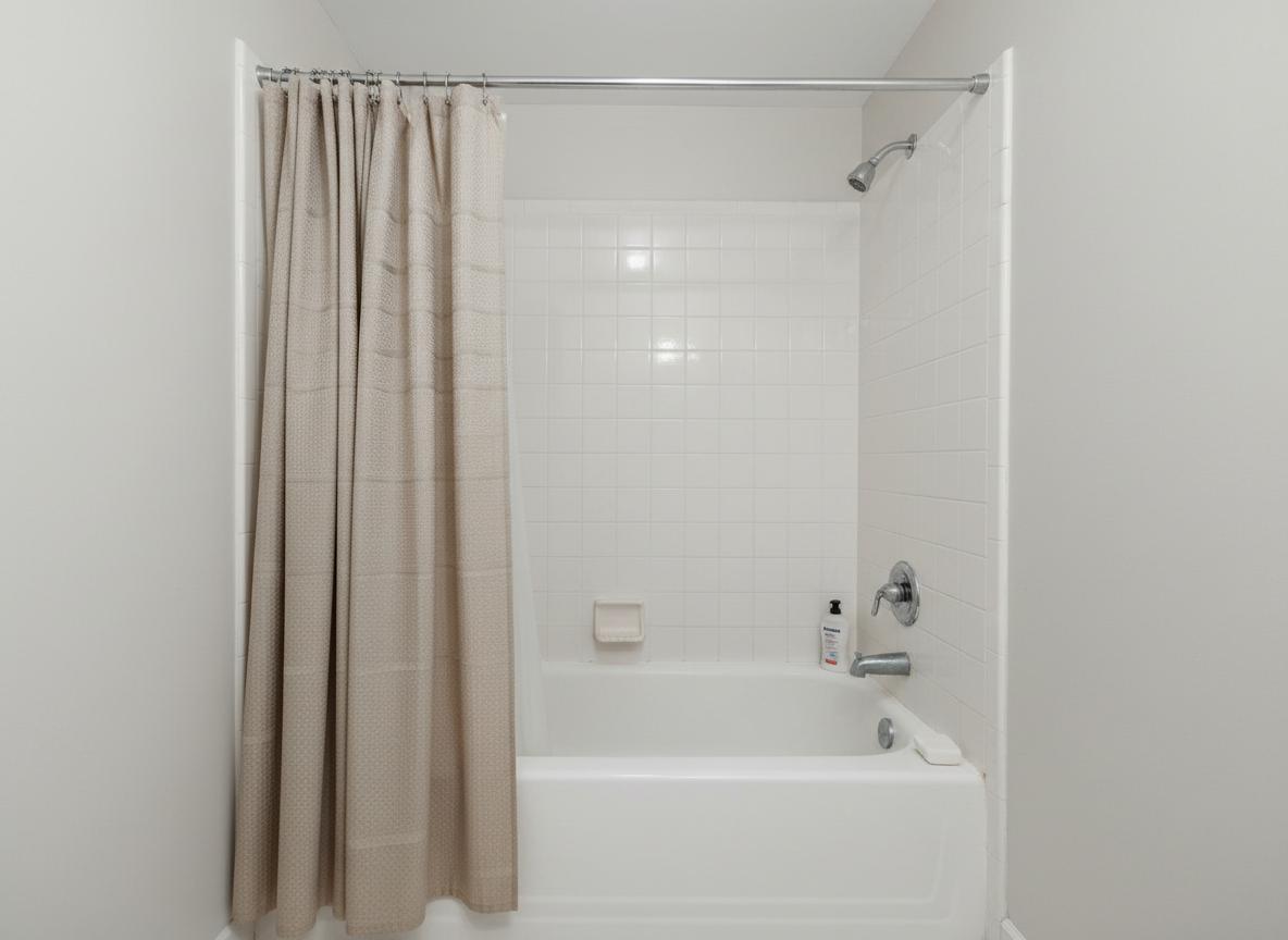 Before: Standard bathtub with no safety grab bars installed